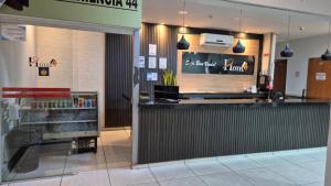 a fast food restaurant with a counter in a store at Shopping 44 Hotel in Goiânia