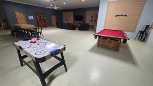 a room with a table with a game on it at The Alderwood Lodge 