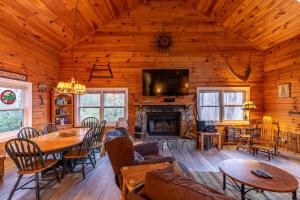 a living room with a table and a fireplace at A Mountain Hideaway in Blowing Rock