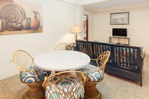 a dining room with a white table and chairs at Family Getaway Suite at Hummingbird Home Suites Gold Standard Certified in San Pedro