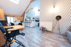 a room with a desk and a table in a room at Loft in Brizambourg