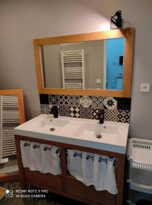 a bathroom with two sinks and a mirror at Loft in Brizambourg +12 photos