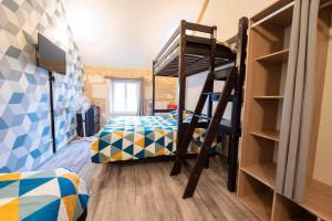 a bedroom with two bunk beds and a ladder at Loft in Brizambourg