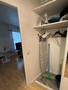 a room with a closet with shelves and a table at Charmant studio à Paris in Courbevoie