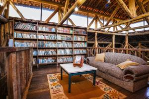 a living room with a couch and bookshelves of books at VELINN Hotel Fazenda Estrela da Serra in Santo Antônio do Pinhal +34 photos