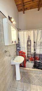 a bathroom with a sink and a shower curtain at LitStay Monoambiente in Córdoba