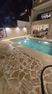 a swimming pool at night in a building at Aloha Imsouane vue sur mer in Imsouane