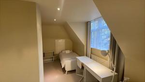 Ένα ή περισσότερα κρεβάτια σε δωμάτιο στο Spacious Notting Hill town house