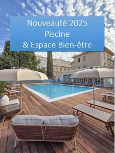 a large swimming pool with chairs and umbrellas next to at Hôtel Miléade L'Orangeraie - Menton in Menton