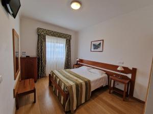 a hotel room with a bed and a window at Hotel Senhora do Espinheiro in Seia +109 photos