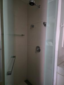 a bathroom with a shower with a glass door at FLAT de luxo mobiliado na Savassi in Belo Horizonte