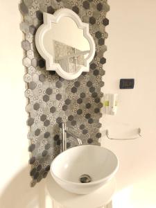 a bathroom with a sink and a mirror on the wall at vittorino in Turin