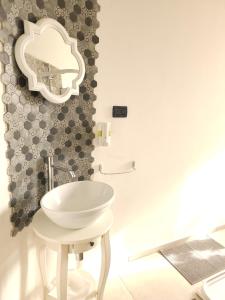 a bathroom with a white sink and a mirror at vittorino in Turin