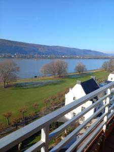 a white house with a view of a body of water at Rheinapartment Dependance 8 in Bad Hönningen