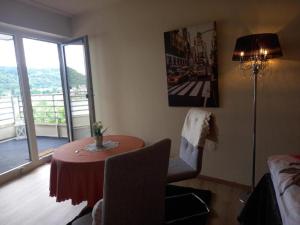 a room with a table and a window with a view at Rheinapartment Dependance 8 in Bad Hönningen +13 photos