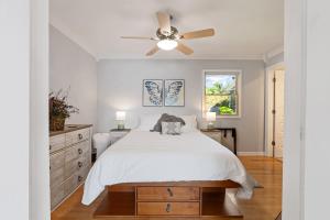 a bedroom with a bed and a ceiling fan at Northbound Stays on Whitefish Lake in Vineland