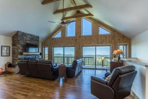 una sala de estar con sofás y una chimenea de piedra. en 4330 Elevation, en Boone