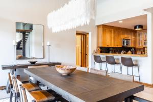 a dining room with a wooden table and chairs at Skycrest Penthouse 1733 in Big Sky