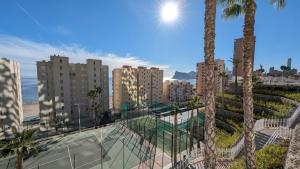 a view of a city with palm trees and buildings at SUNSET CLIFFS fantastic apartment in Benidorm