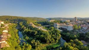 an aerial view of a city with a river at Meridian Hotel Bolyarski in Veliko Tŭrnovo