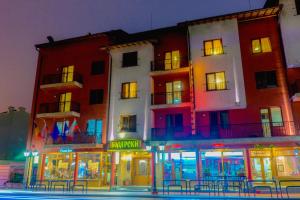 a group of buildings on a city street at night at Meridian Hotel Bolyarski in Veliko Tŭrnovo
