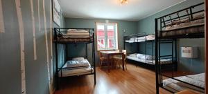 a room with four bunk beds and a table at Abisko net Hostel & Huskies in Abisko
