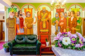 a living room with a painting on the wall at Meridian Hotel Bolyarski in Veliko Tŭrnovo