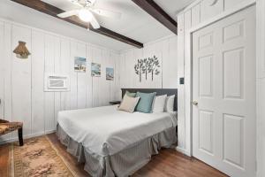 a bedroom with a bed with white walls and a ceiling at Rustic Cabin Getaway Close to Everything Fun! in Beaver Dams