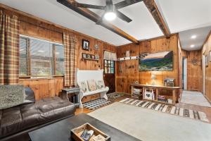 a living room with wooden walls and a ceiling at Rustic Cabin Getaway Close to Everything Fun! in Beaver Dams