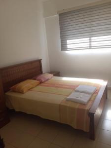 a bedroom with a bed with two towels on it at SkyLine 19 Apartment in Colombo