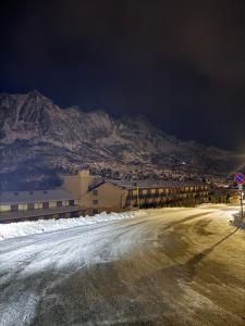an empty road in front of a mountain at night at Lo Chalet delle Marmotte in Passo del Tonale