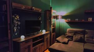 a living room with a couch and a television at Ferienwohnung Buchholzer Straße 1 in Annaberg-Buchholz +13 photos