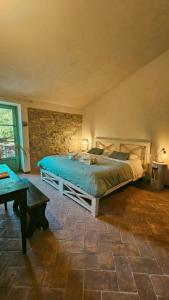 a bedroom with a bed and a stone wall at 16Th Century Farmhouse Between The Tuscan Hills in Brancorsi