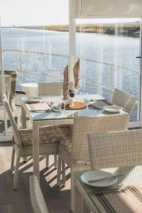 a dining table and chairs on a boat at Chobe Princess by Mantis in Kasika