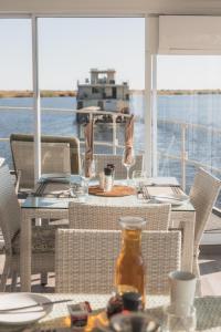 a table and chairs on a boat with a view of the water at Chobe Princess by Mantis in Kasika +73 photos