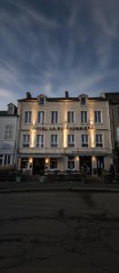 a large white building with lights in front of it at La Buissonnière in Corbigny