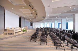 an empty conference room with chairs and tables at Isola di Albarella Hotel Capo Nord in Isola Albarella +178 photos
