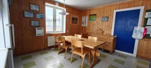 a dining room with a wooden table and chairs at Abisko net Hostel & Huskies in Abisko