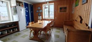 a dining room with a wooden table and chairs at Abisko net Hostel & Huskies in Abisko +16 photos