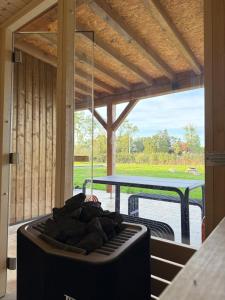a patio with a table and a couch in a room at Le Secret in Lusigny