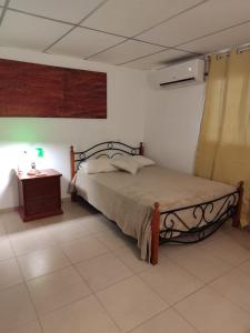 a bedroom with a bed and a side table at Casa Punta Chame in Punta Chame