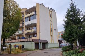an apartment building with a car parked in front of it at kawalerka w centrum Grajewa in Grajewo