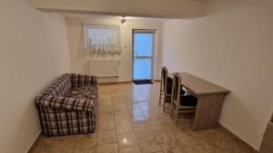 a living room with a couch and a table at kawalerka w centrum Grajewa in Grajewo