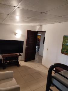 a living room with a flat screen tv on the wall at Casa Punta Chame in Punta Chame