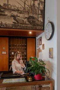 a woman sitting at a desk in a office at Hotel Rivamare in Venice-Lido