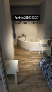 a bathroom with a tub and a table and a bed at Via Trento 30 in Salerno +148 photos