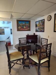 a dining room with a table and a piano at Casa Punta Chame in Punta Chame +9 photos