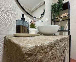 a bathroom with a sink and a bowl on a table at Biscoitos-Upstudio in Biscoitos +26 photos