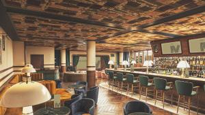 a large room with a bar with chairs and tables at Mollie's Manchester in Manchester +25 photos