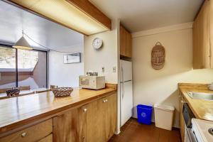 a kitchen with wooden cabinets and a counter top at Notchbrook 28AB in Stowe